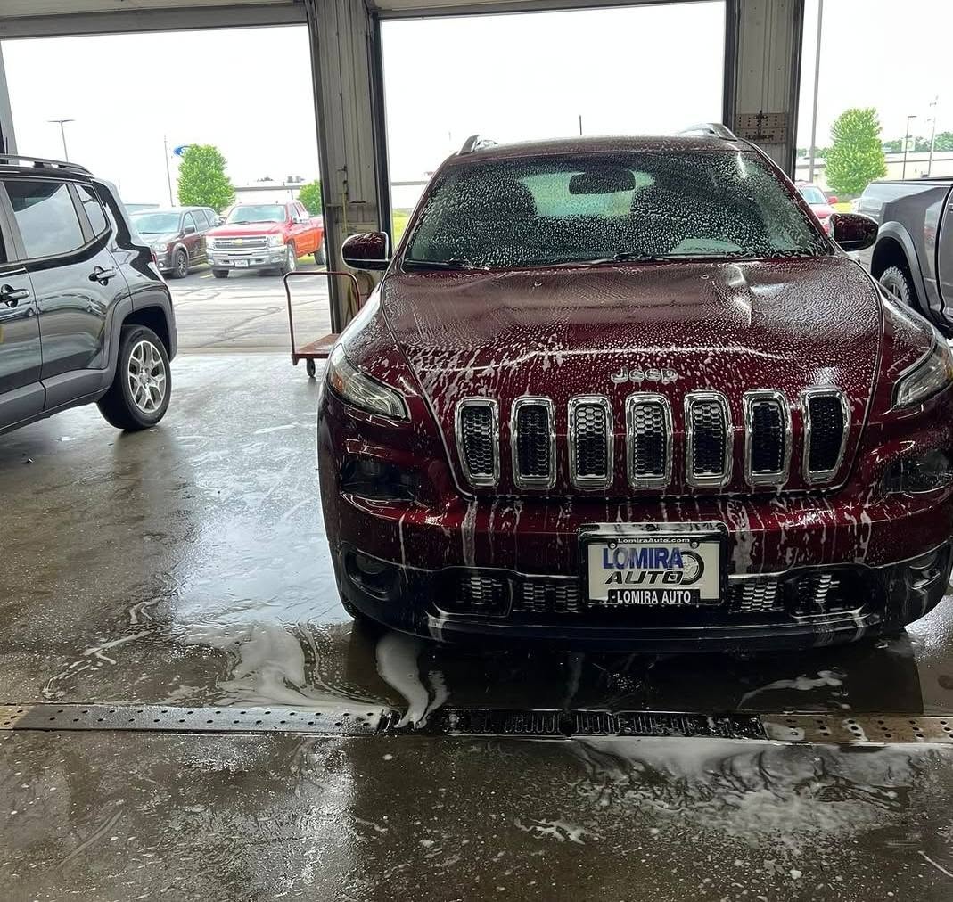 Foam wash on a red SUV